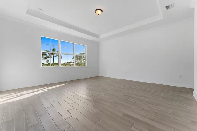 a bathroom with a granite countertop sink a toilet and a window