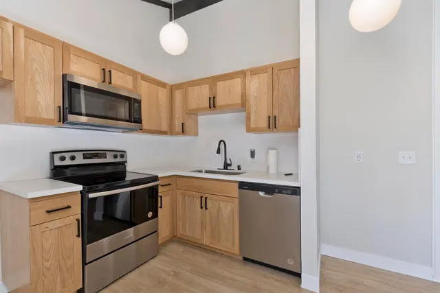 a kitchen with stainless steel appliances granite countertop a stove and a sink