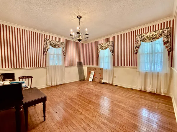 an empty room with windows and entrance
