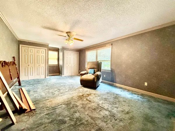 a view of a room with wooden floor and windows