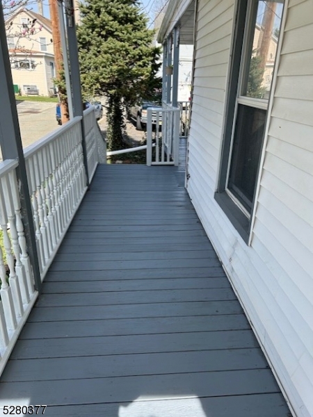 a view of a porch with wooden floor and stairs