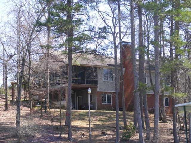 a front view of a building with trees