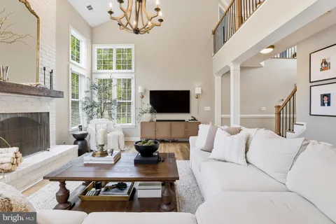 a living room with furniture a flat screen tv and a large window