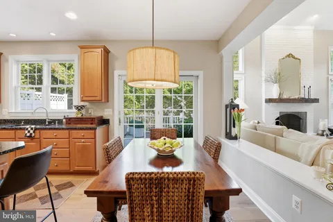 a living room with fireplace furniture and a large window