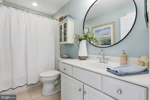 a living room with furniture and floor to ceiling windows