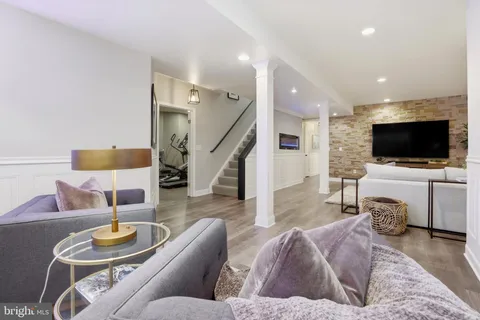 a bathroom with a granite countertop sink a toilet and a mirror