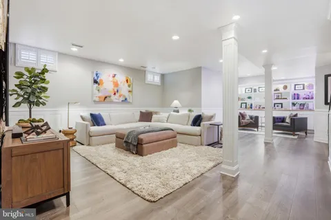 a bedroom with a bed and paintings on the wall