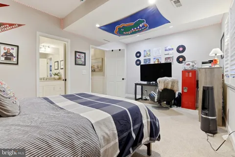 a view of a house with a yard and large trees