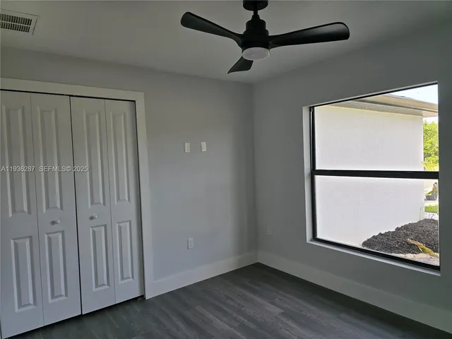 a view of a small space with wooden floor closet and windows