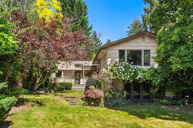 a front view of house with yard and trees