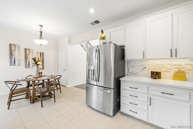 a kitchen with granite countertop cabinets and refrigerator