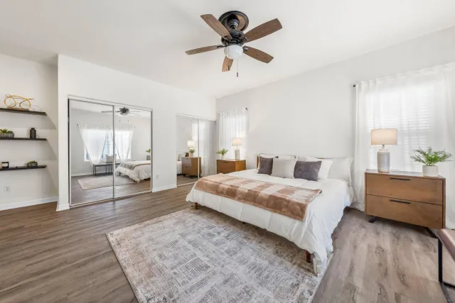 a spacious bedroom with a bed and a chandelier