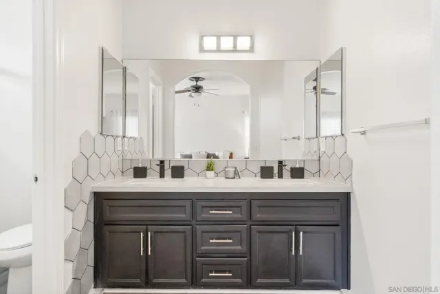 a bathroom with a double vanity sink and a mirror