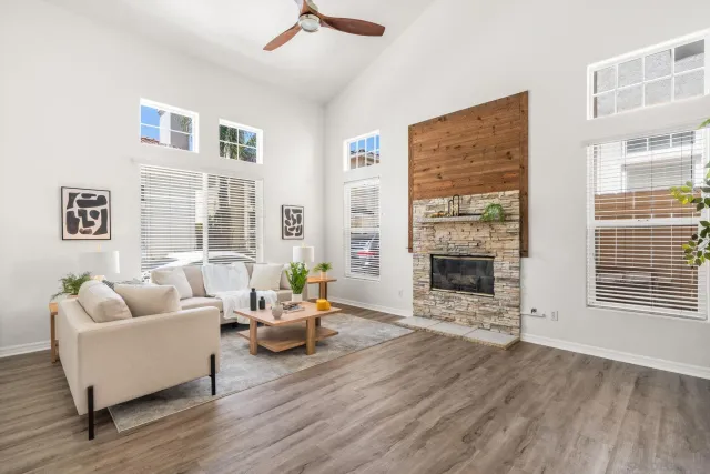 a living room with furniture a fireplace and a flat screen tv