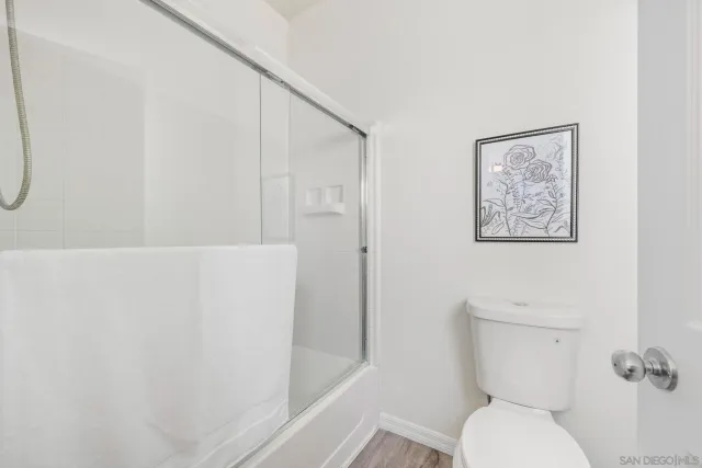 a white toilet sitting next to a bathroom sink
