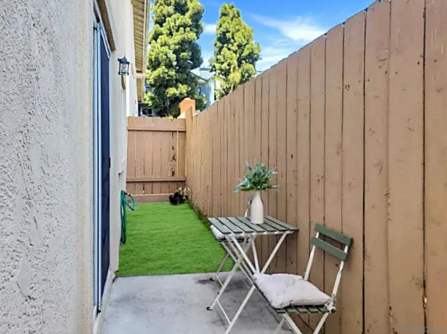 a view of a backyard with chairs