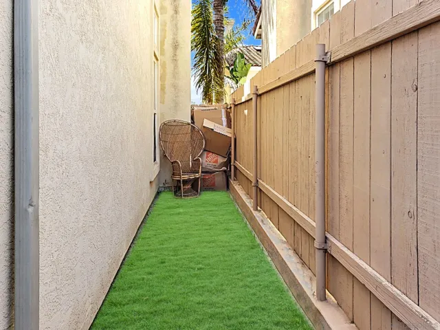 a view of a backyard with wooden fence