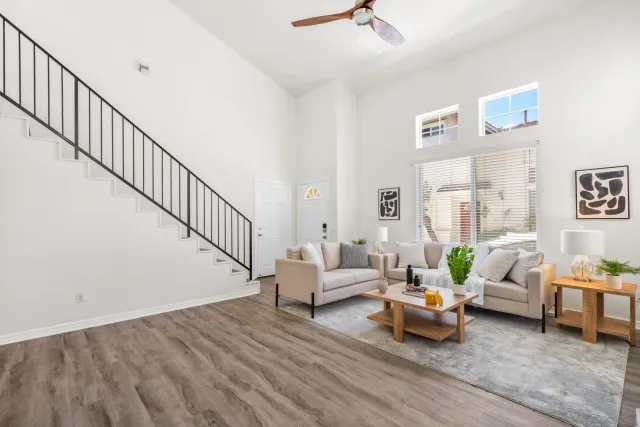 a living room with furniture and wooden floor
