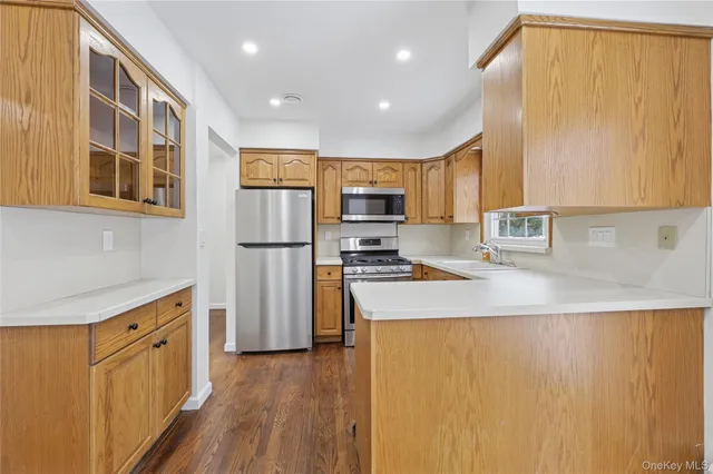 a kitchen with stainless steel appliances a refrigerator and a stove top oven