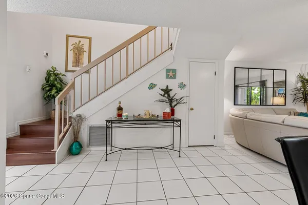 a living room with furniture a rug and white walls