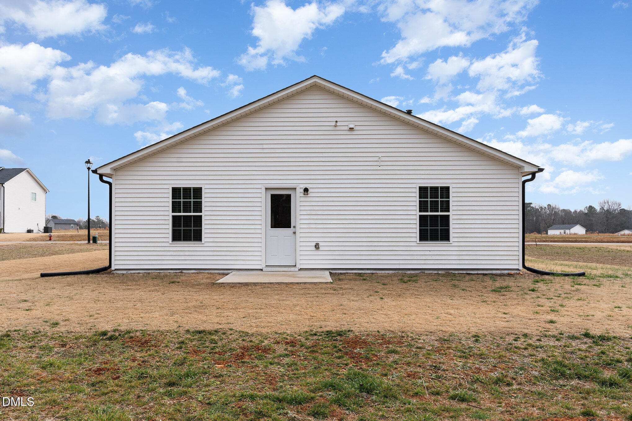 385 Dasu Drive, Unit 1 Clayton, NC 27520 - Photo 16 of 17 a view of a house with a yard
