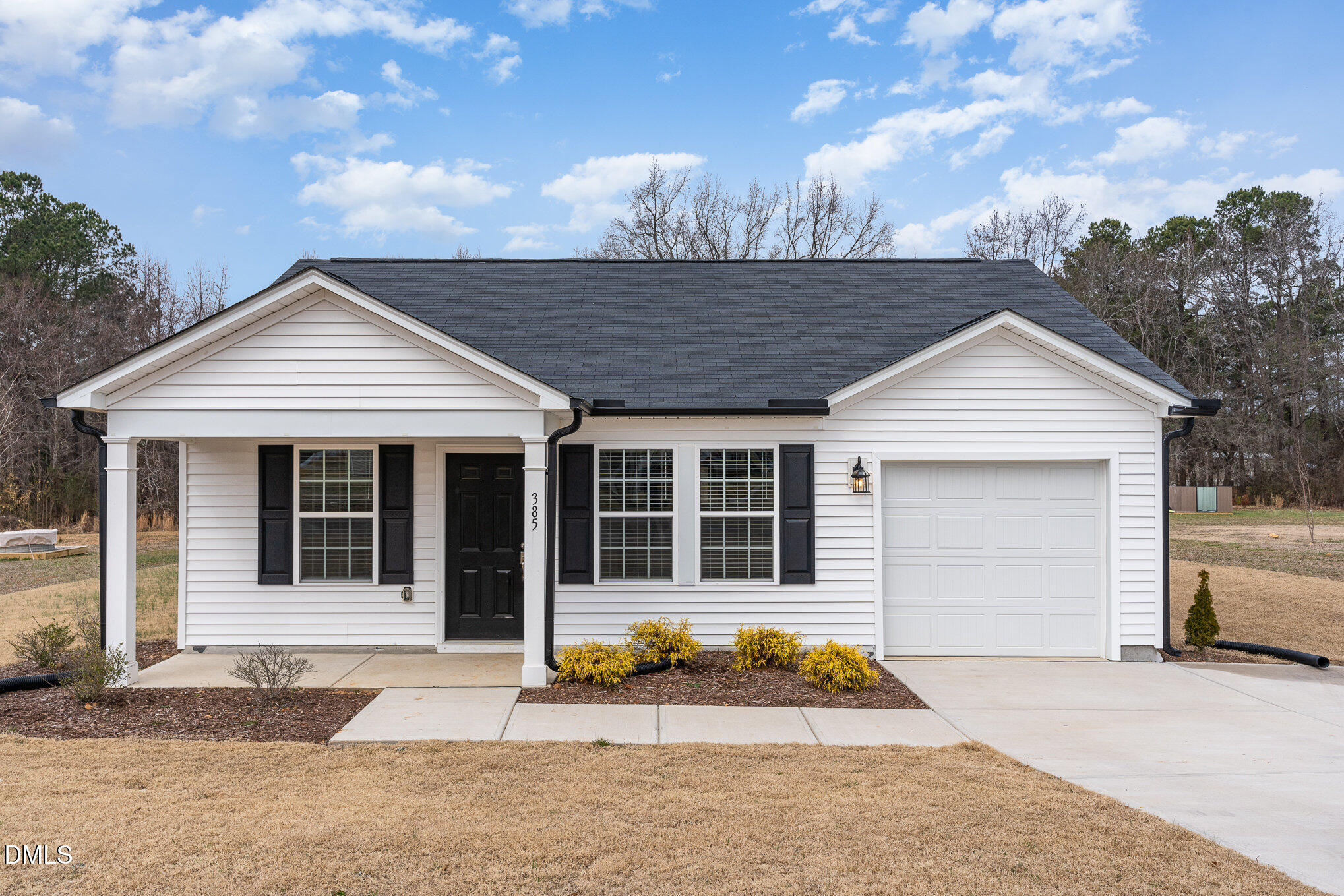 385 Dasu Drive, Unit 1 Clayton, NC 27520 - Photo 3 of 17 a front view of a house with garden