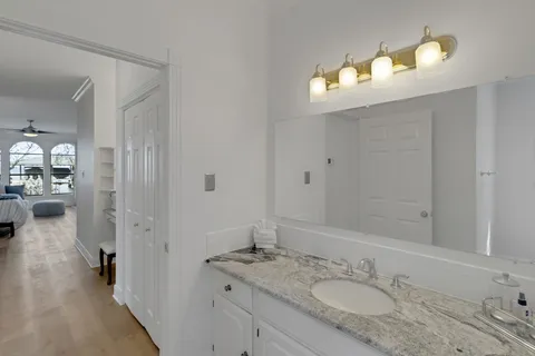 a bathroom with a toilet a sink and mirror