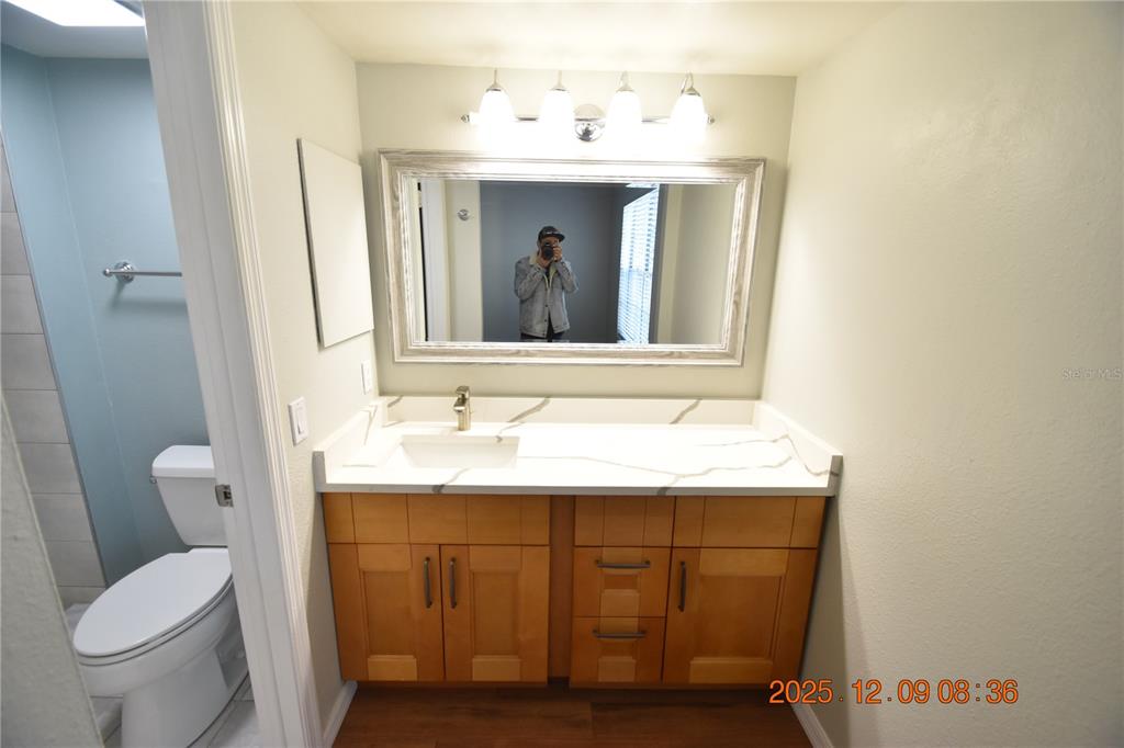 3402 Latania Drive, Unit 316 Tampa, FL 33618 - Photo 13 of 36 a bathroom with a toilet sink and mirror