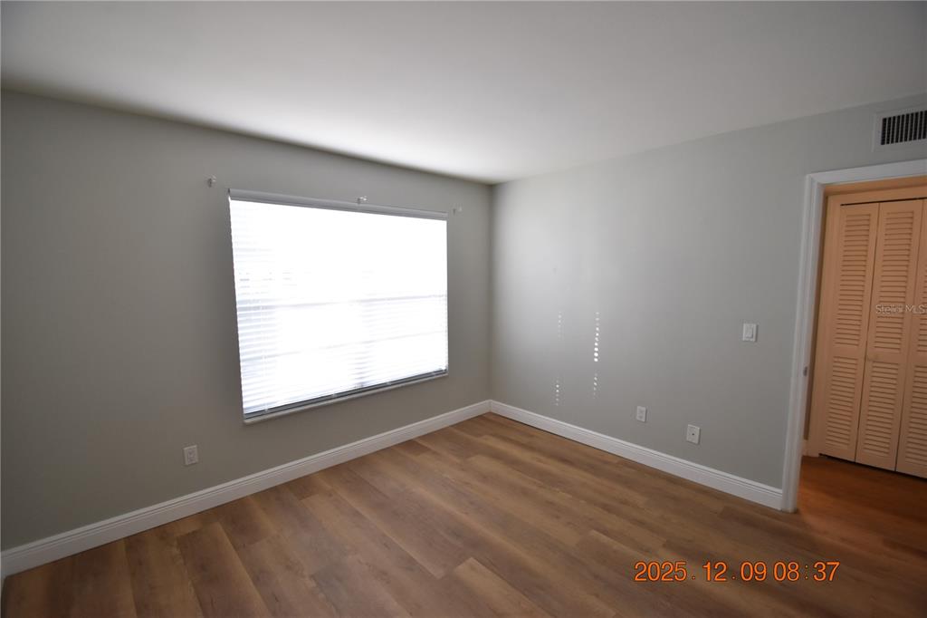 3402 Latania Drive, Unit 316 Tampa, FL 33618 - Photo 16 of 36 an empty room with wooden floor and windows