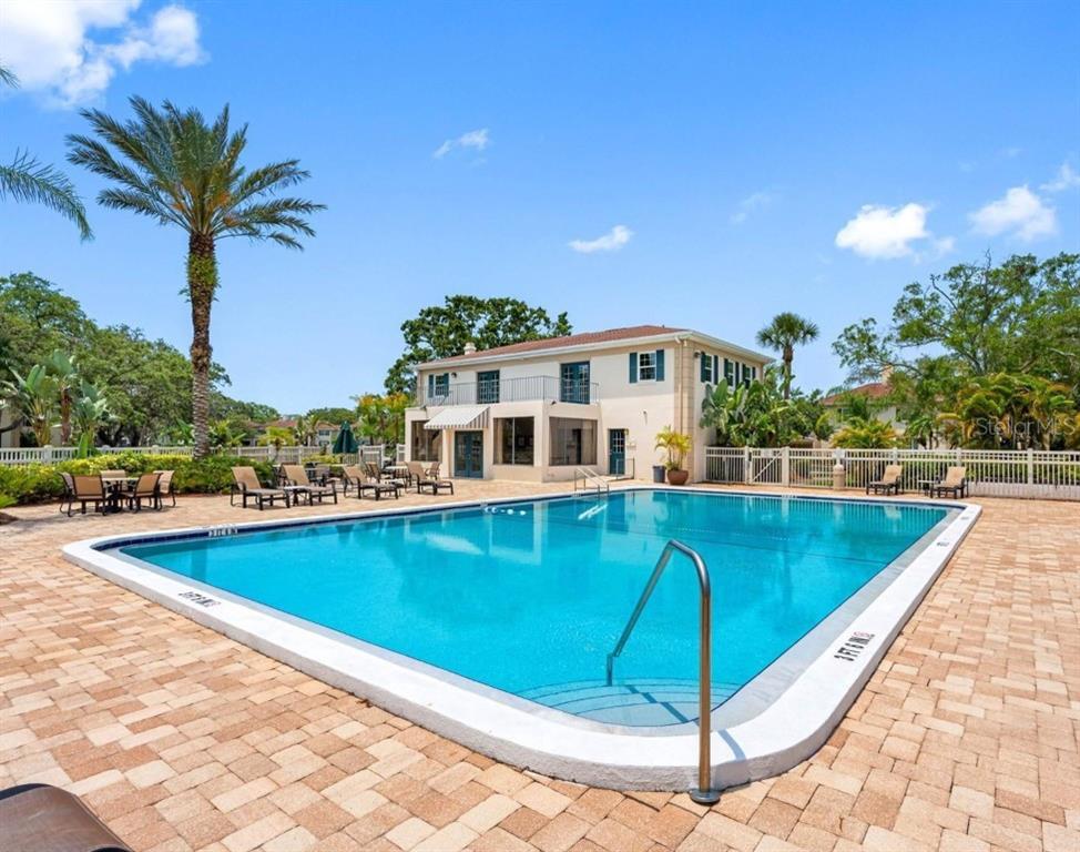 3402 Latania Drive, Unit 316 Tampa, FL 33618 - Photo 28 of 36 a view of a swimming pool with a lounge chair