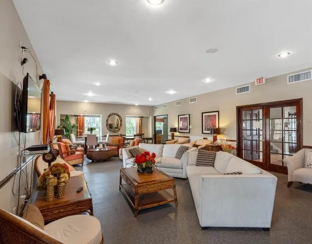 a living room with furniture fireplace and a large window