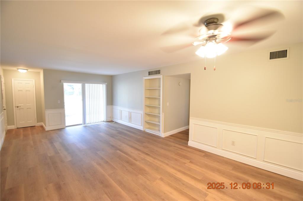 3402 Latania Drive, Unit 316 Tampa, FL 33618 - Photo 6 of 36 an empty room with wooden floor fan and windows