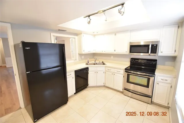 a kitchen with a refrigerator stove and microwave