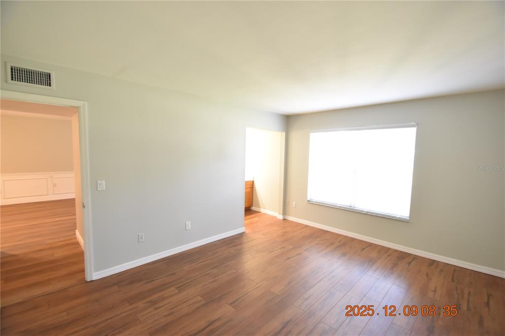 3402 Latania Drive, Unit 316 Tampa, FL 33618 - Photo 9 of 36 an empty room with wooden floor and a window