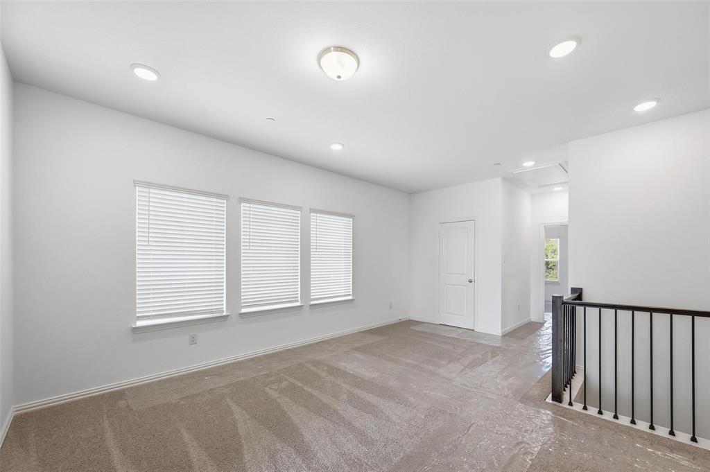 1168 Daybreak Drive, Unit 1168 Allen, TX 75013 - Photo 8 of 25 Carpeted living space with multiple windows, recessed lighting, and a white paneled door