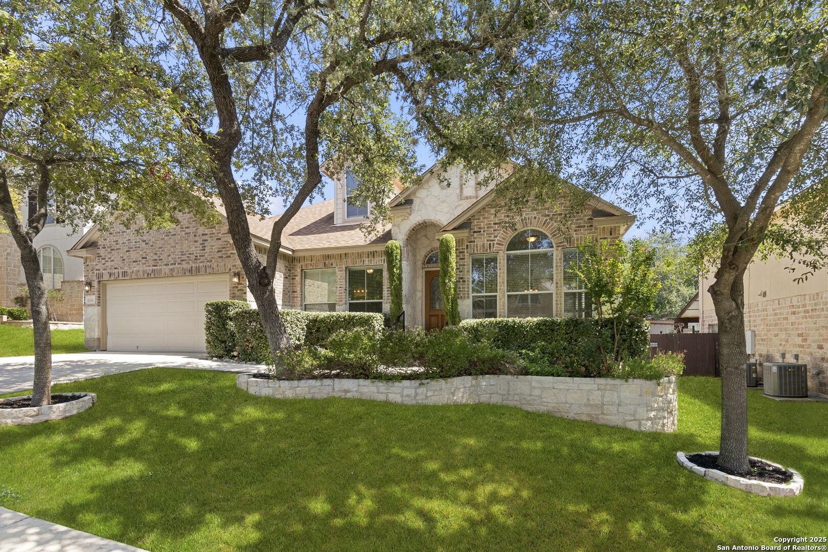 16106 Ponderosa Pth Helotes, TX 78023 - Photo 1 of 40 a front view of a house with a yard and tree