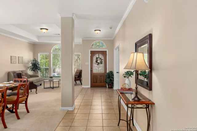 a living room with furniture a fireplace and a potted plant