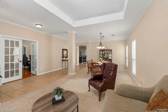 a living room with furniture and a chandelier