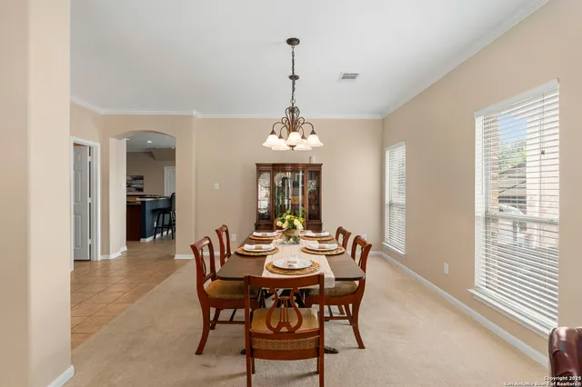a dining room with furniture window and wooden floor