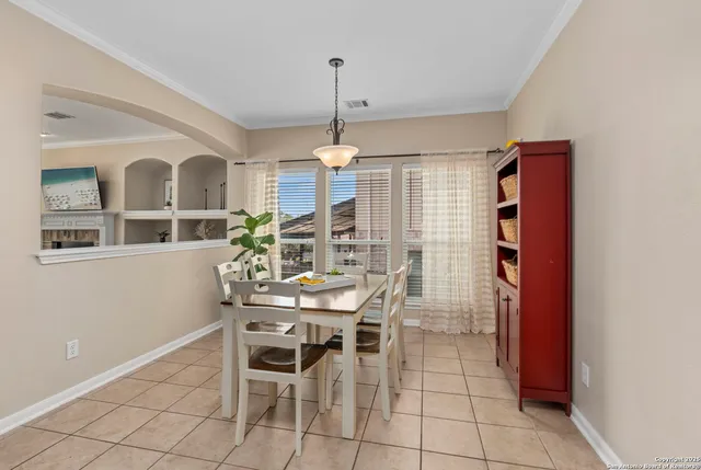 a dining room with furniture and window