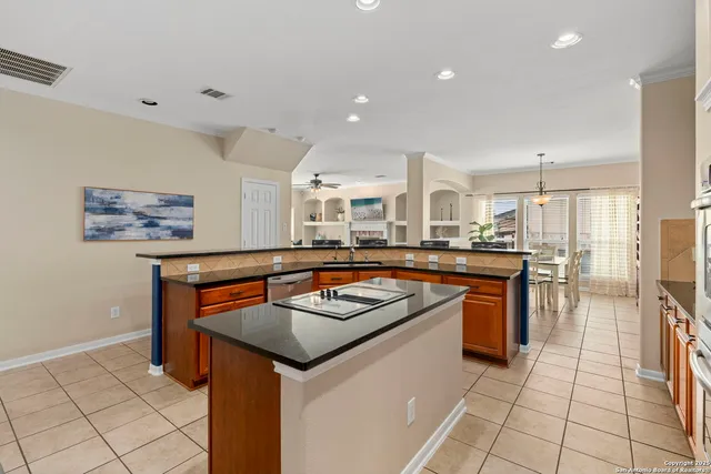 a kitchen with stainless steel appliances granite countertop a stove a sink and a refrigerator