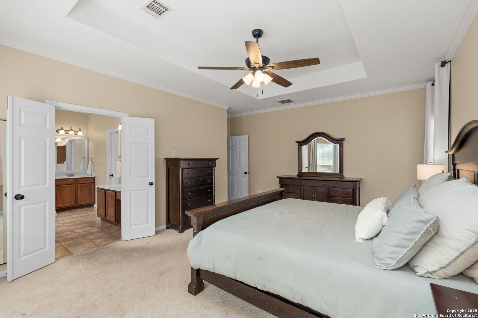 16106 Ponderosa Pth Helotes, TX 78023 - Photo 22 of 40 a bedroom with a bed and a chandelier
