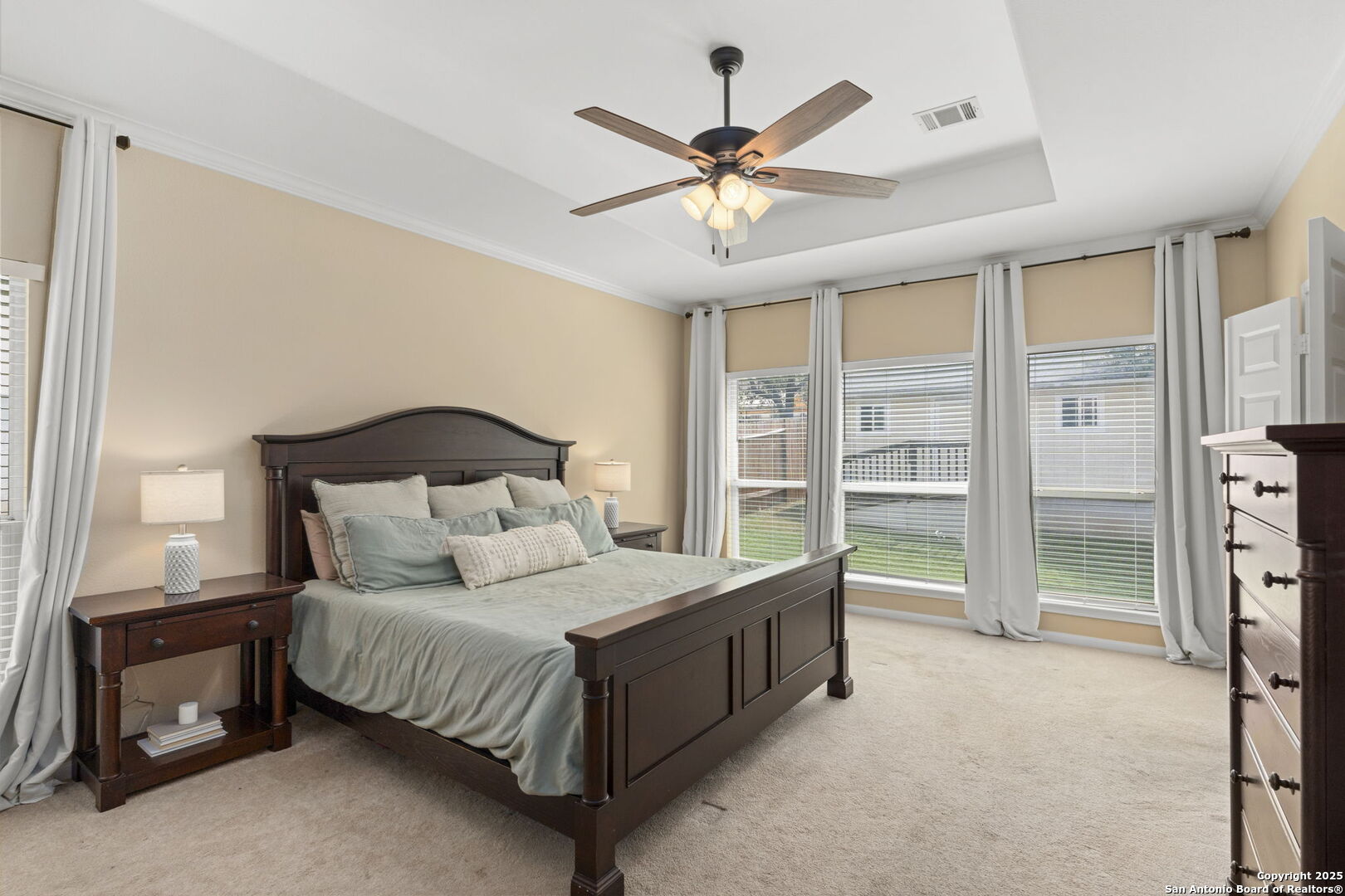 16106 Ponderosa Pth Helotes, TX 78023 - Photo 23 of 40 a bedroom with a bed and a chandelier