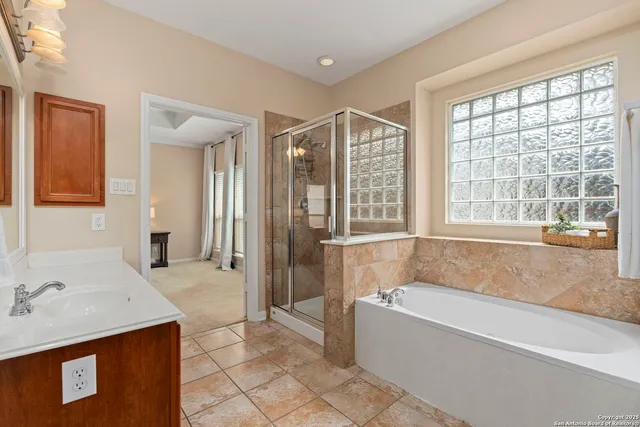 a bathroom with a tub sink and mirror