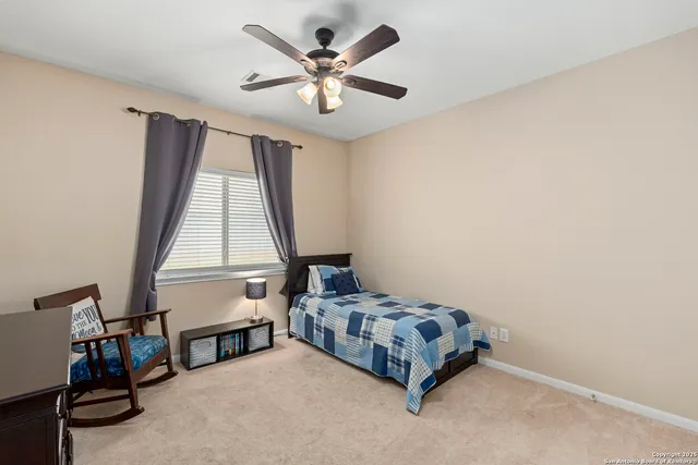 a bedroom with a bed a window and a chandelier