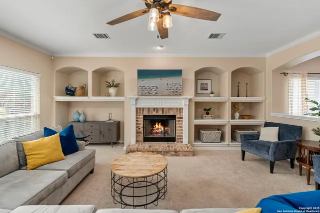 a living room with furniture and a fireplace