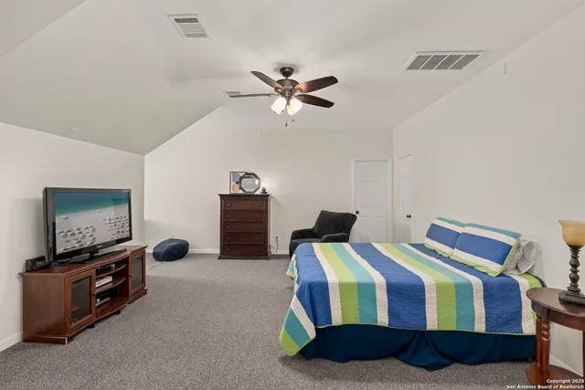a bedroom with bed and a chandelier