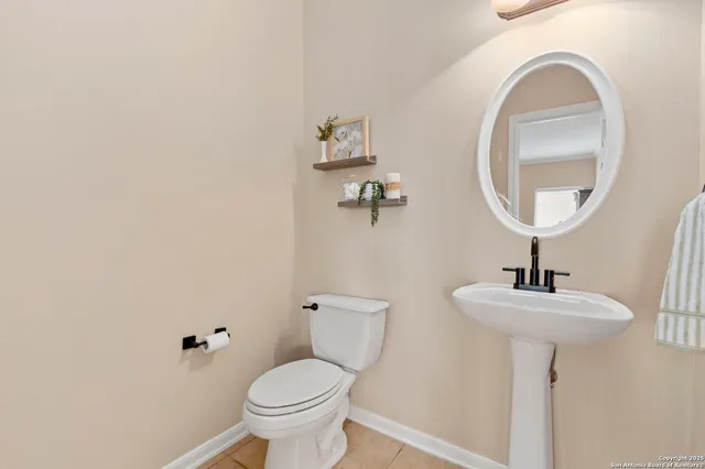 a bathroom with a sink a mirror and a toilet