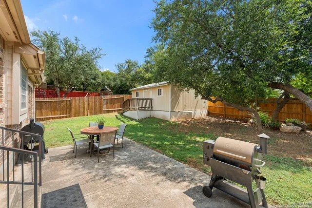 a backyard of a house with outdoor seating