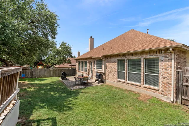 a view of a house with a yard and sitting area